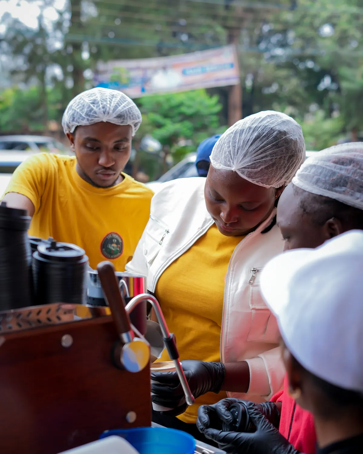 Baristas in hairnets working the espresso machine