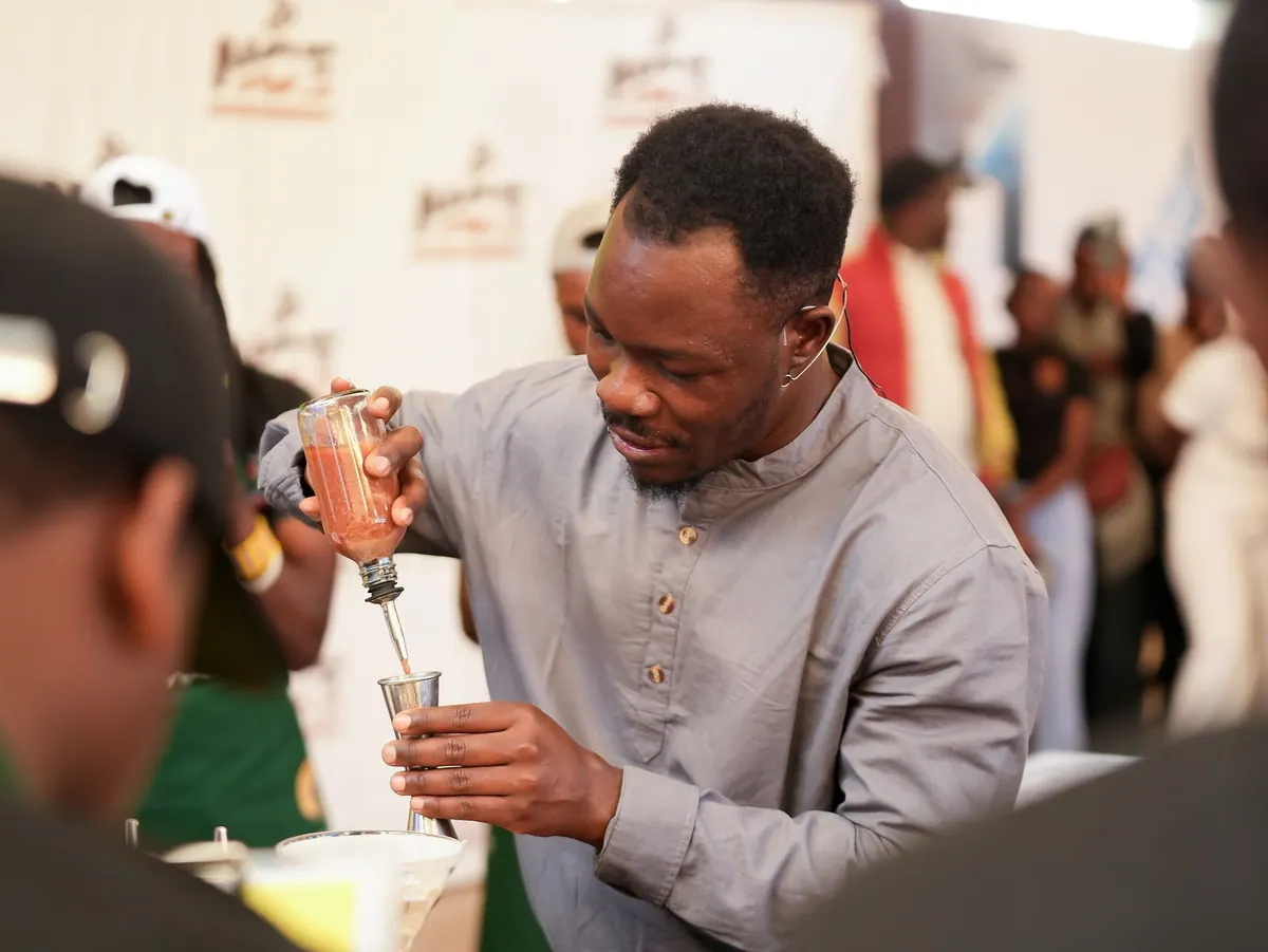 A man pouring coffee from a small jug into a glass