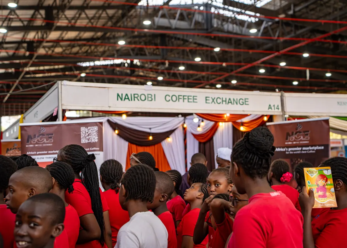 Pupils in red uniforms queuing at the Nairobi Coffee Exchange stand